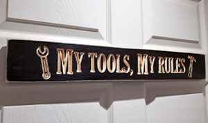 A sign on a door that says "my tools, my rules".